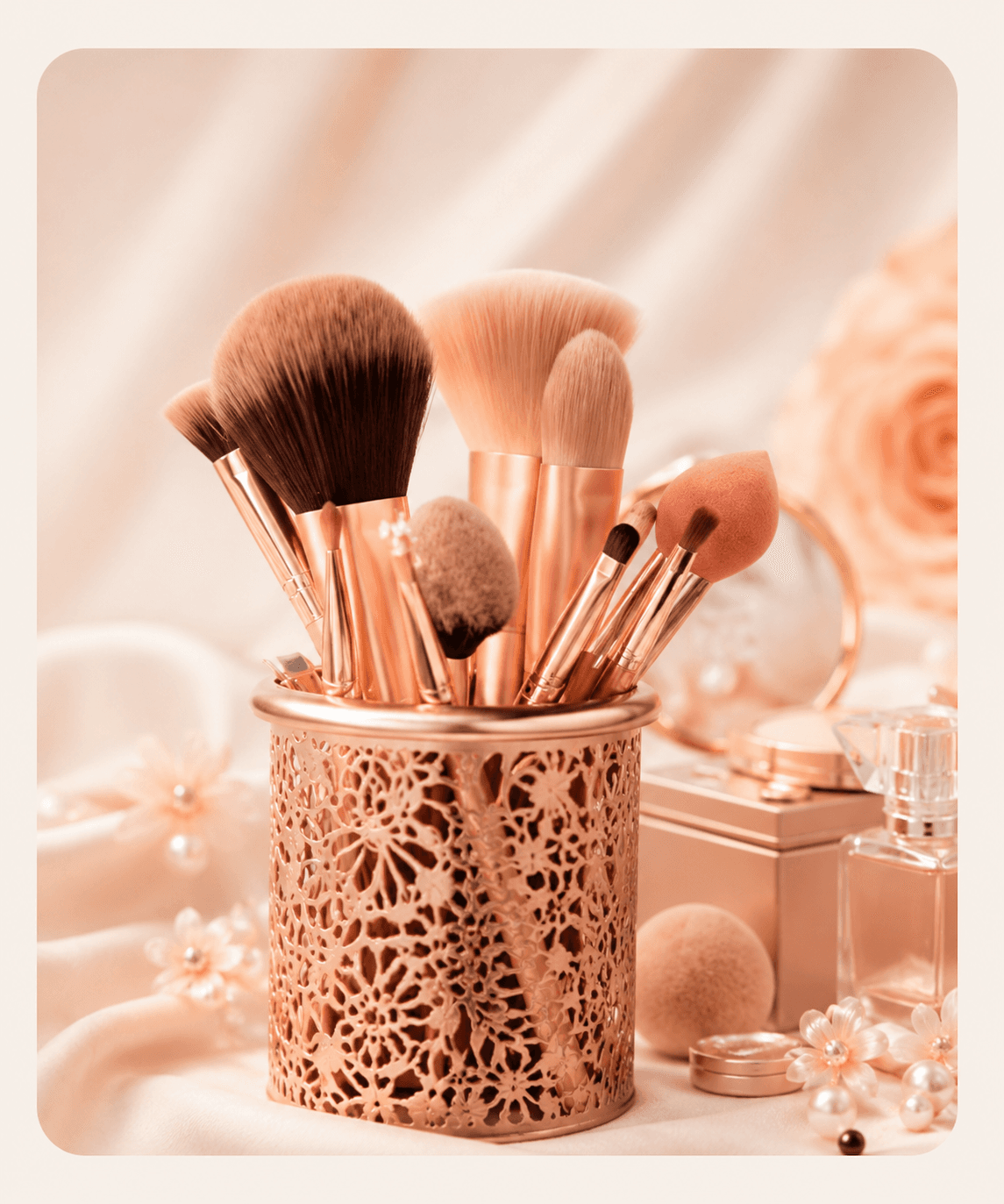 Rose gold makeup brushes and beauty accessories on silk